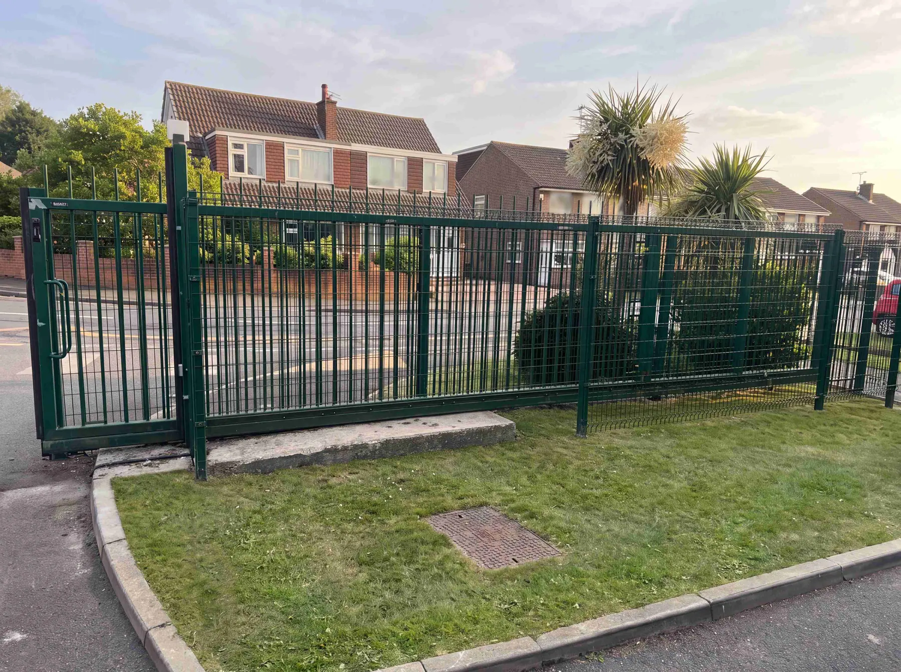 Green weldmesh security fencing installed along a commercial boundary