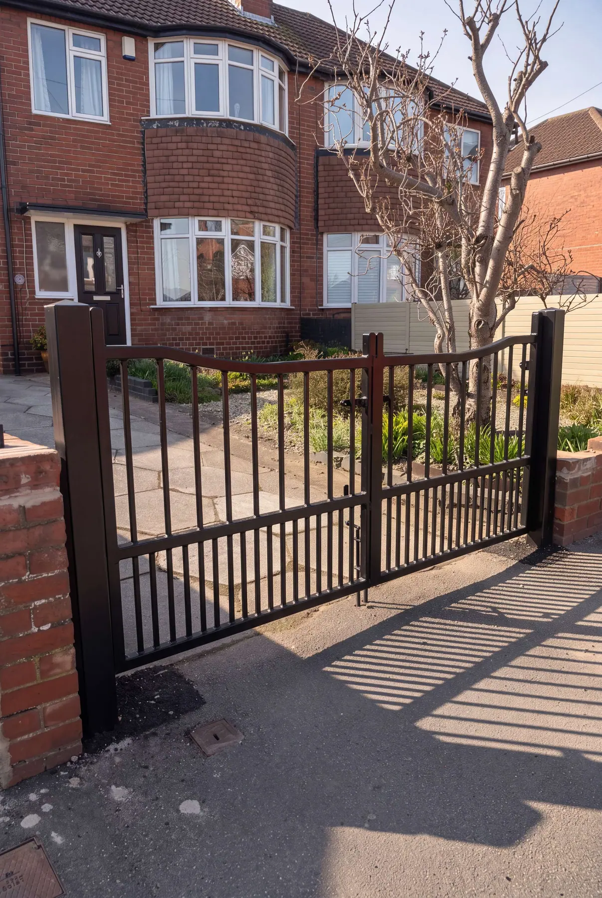Bronze-finished manual gates with matching railings