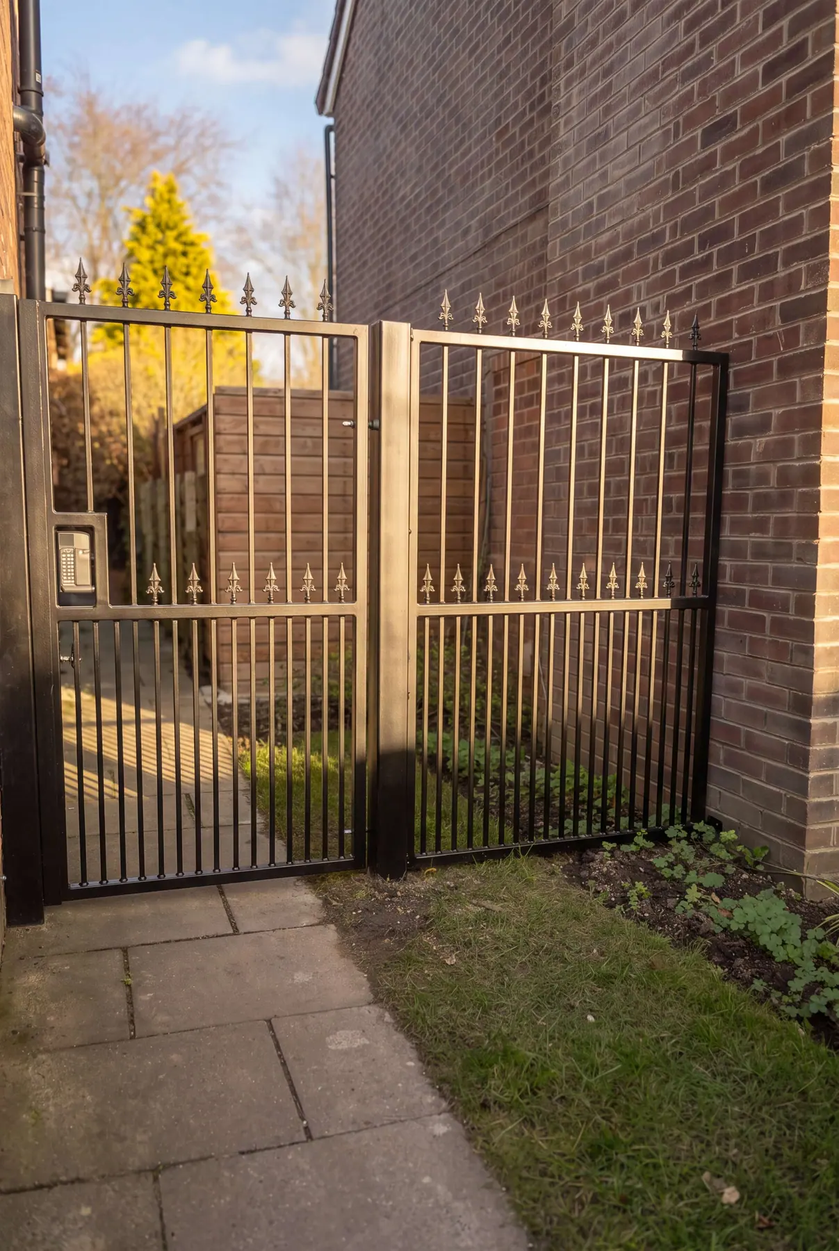 Bronze-finished manual gates with matching railings
