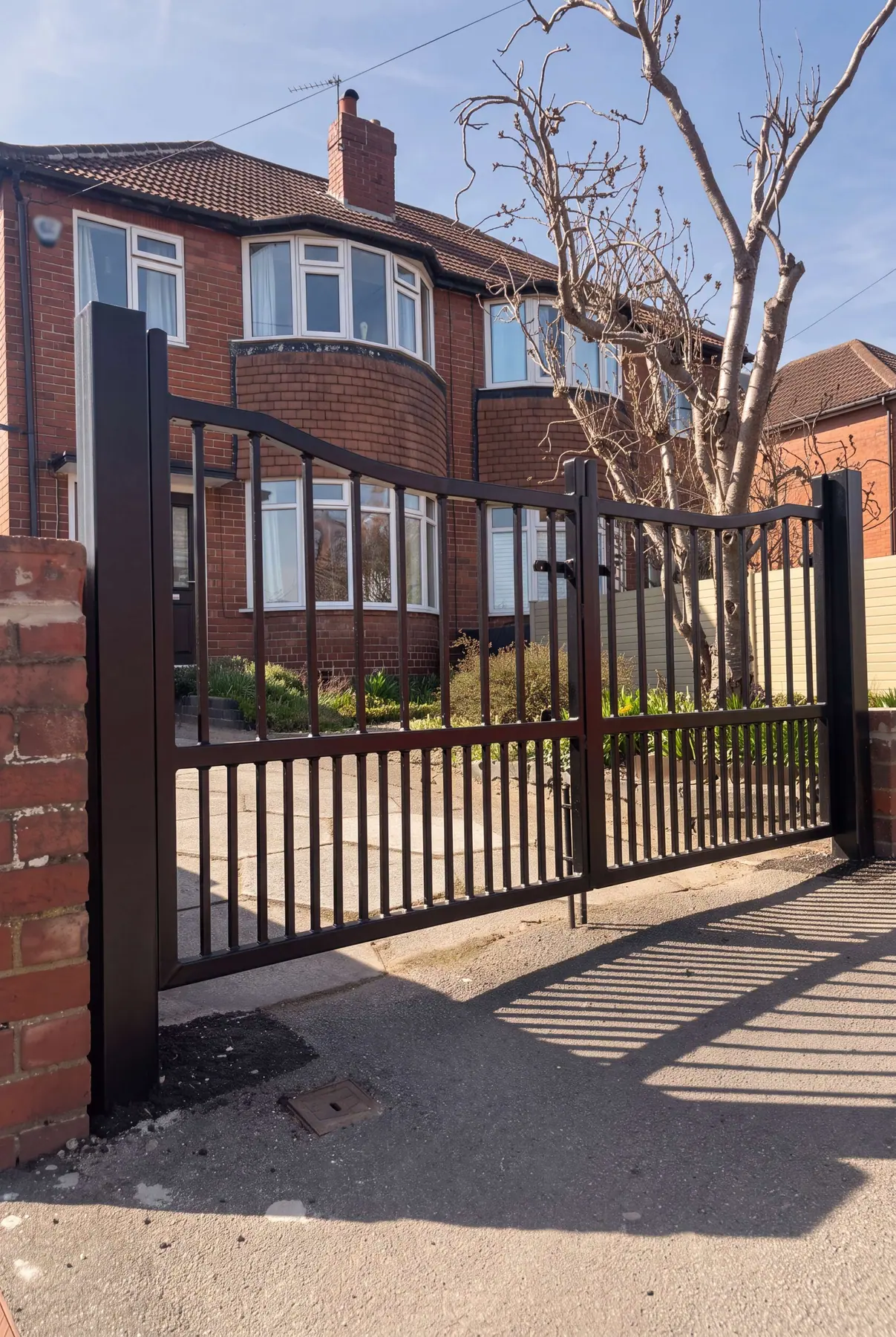 Bronze-finished manual gates with matching railings