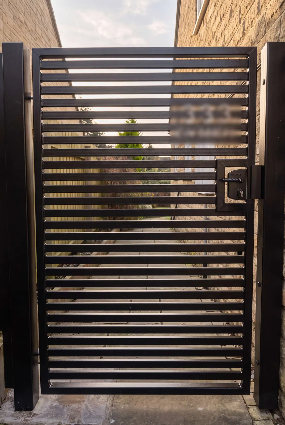 Grey horizontal-slat manual gate with a flush handle