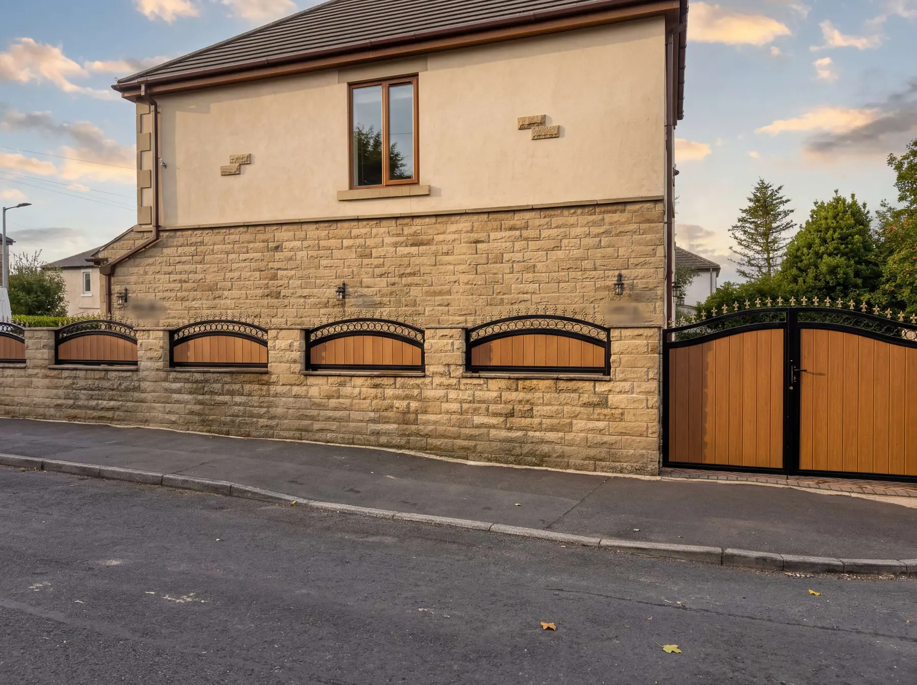 Timber-panelled manual gates with arched detailing at a stone house